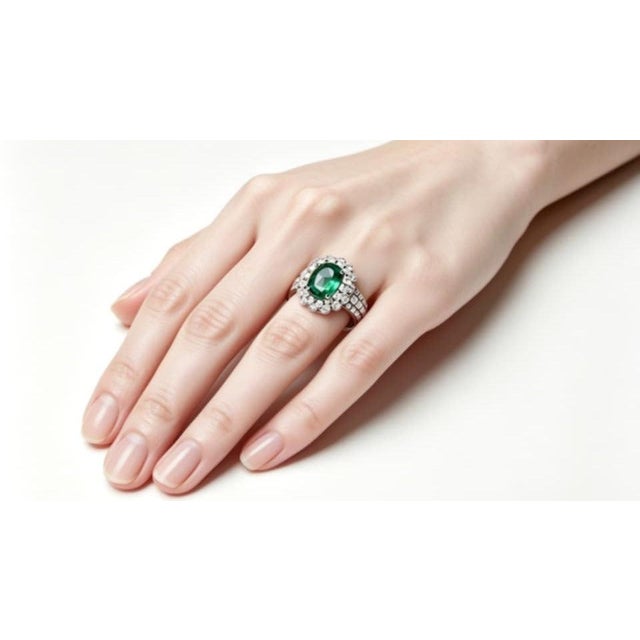 This gorgeous 18K white gold ring features: Emerald: 1.8 carat natural oval, super quality, G color, VS clarity Diamonds:...