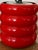 Vintage postmodern table lamp featuring a bold stacked cylindrical base in a vibrant gloss red finish. The playful,...