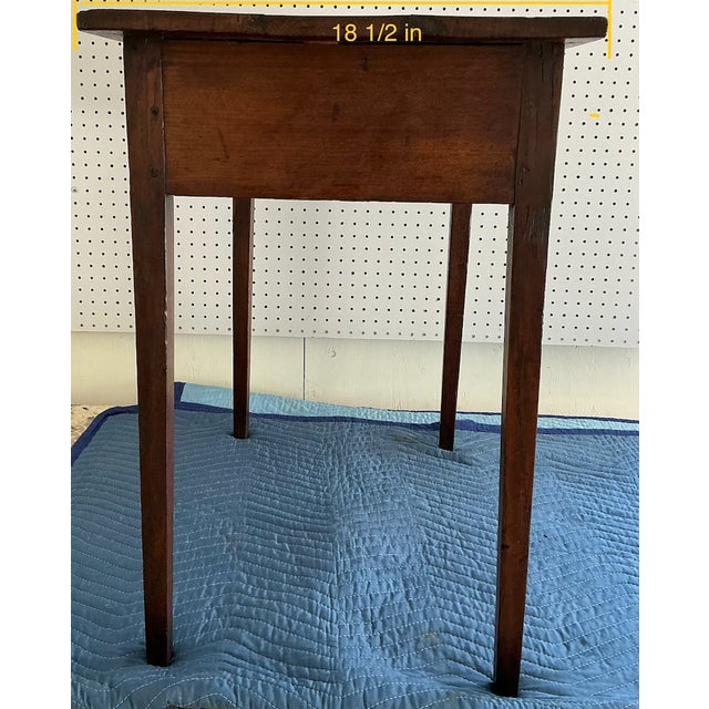 19th Century English Oak Side Table with a single drawer and tapering legs. This item has patina, adding to its rustic charm.