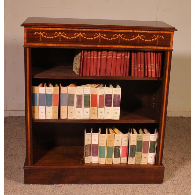 Charming small open bookcase in mahogany with English inlays. This small, uncommon model is decorated with wood marquetry...