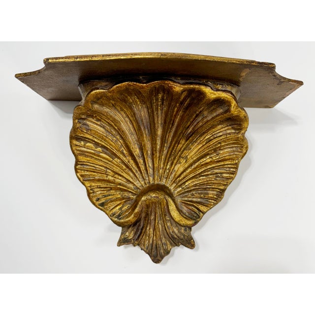 Vintage gilded wood shell motif wall shelf. Wonderful facing shell detail with beveled edge to shelf. Age wear. Hooks for...