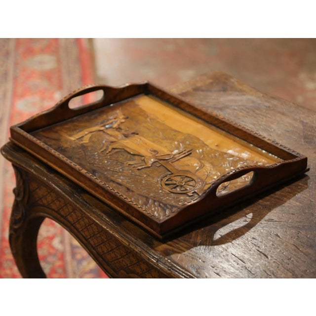 Richly carved with a lively rural scene, this antique serving tray is a charming example of French art populaire. Crafted...