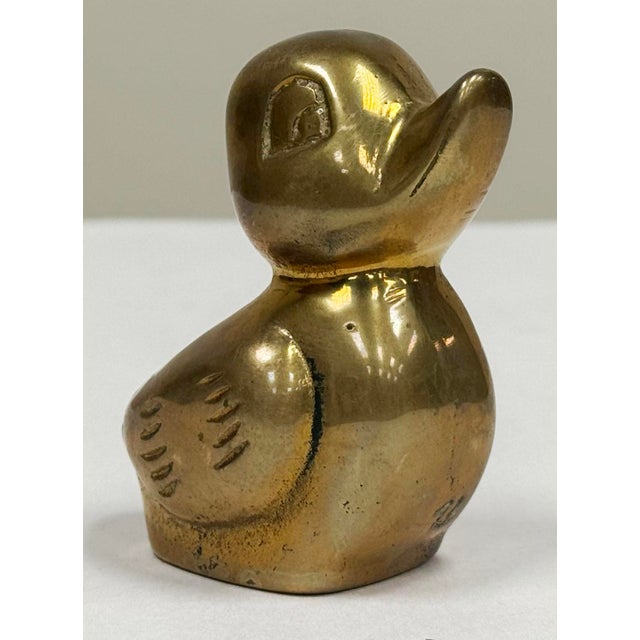 Vintage adorable brass duckling figure. Cute addition to a nursery windowsill or child's bath. Nice patina.
