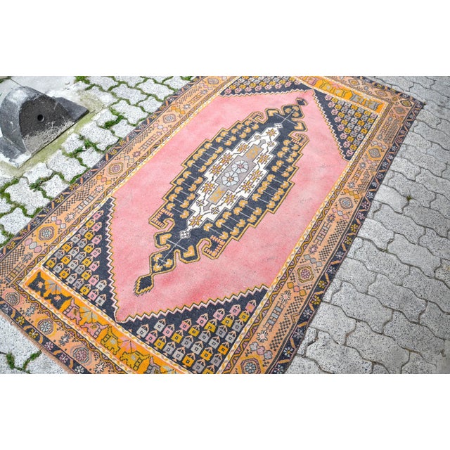 This is a vintage Turkish Oushak rug from the 1960s. The piece was hand-knotted.