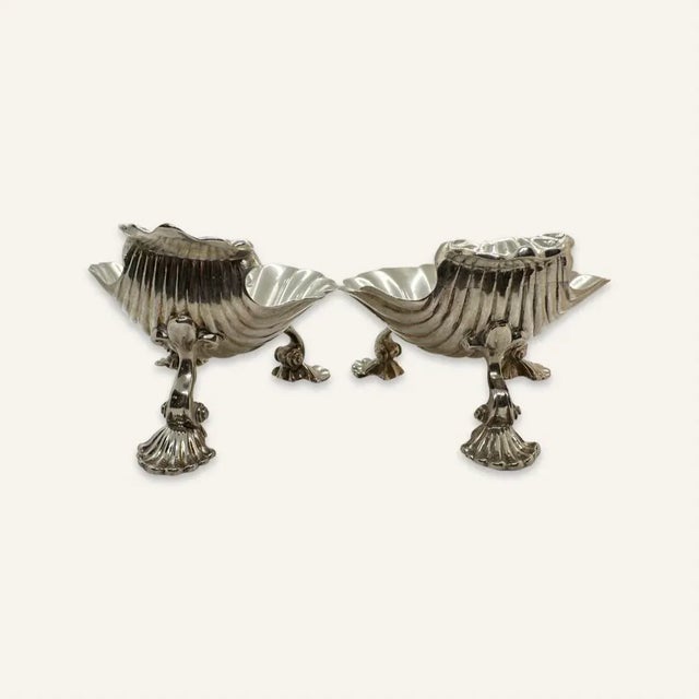 This is a pair of Victorian heavy gauge sterling silver master salt cellars in shell form. The hallmarks are worn on one,...