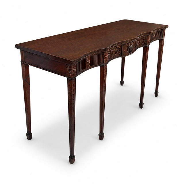 This is a statement piece! This is a 1940s Italian neoclassical style carved mahogany console table or sideboard with a...