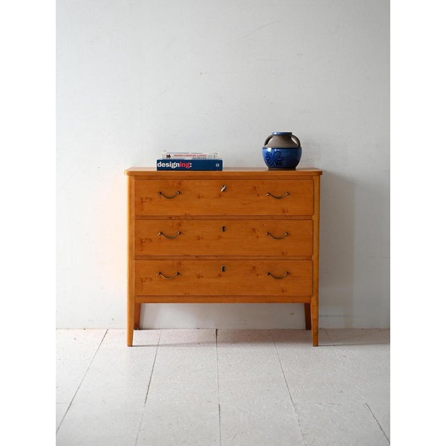 Mid-century burl birch chest of drawers with three drawers and a key lock. Clean lines and metal details. Vintage...