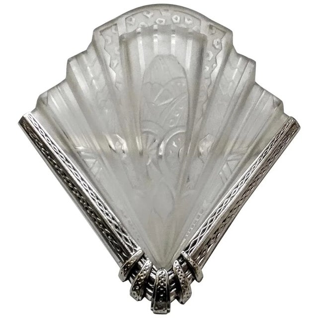 A pair of French Art Deco wall sconces signed "FRONTISI" in clear frosted glass shades with intricate flower motif details...
