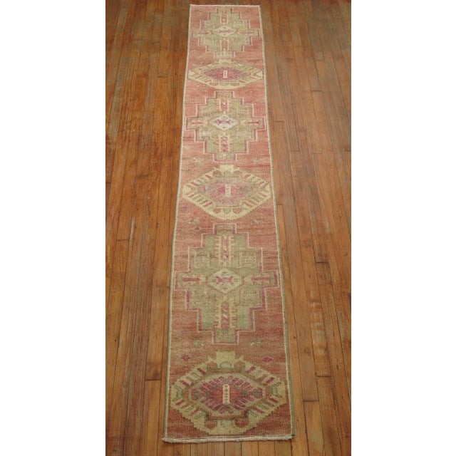 One of a kind wool hand-knotted 20th century Turkish Runner in a predominant muted Pink.