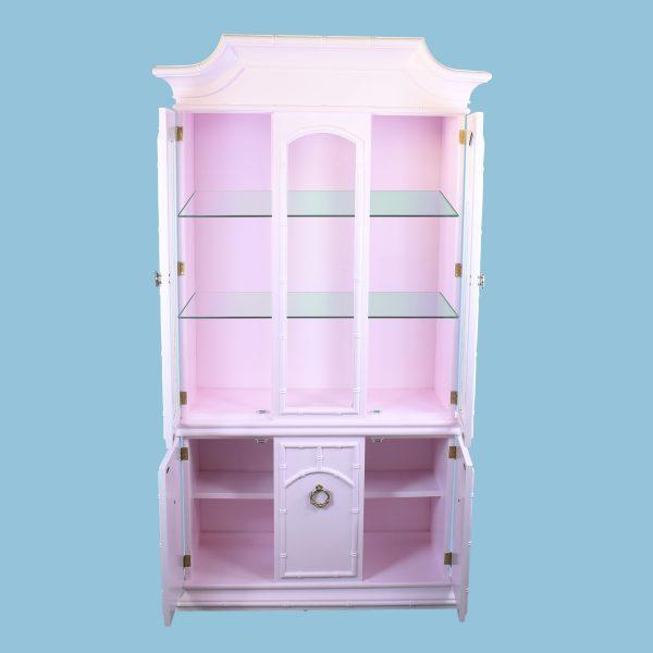 A pink faux bamboo cabinet crowned with a pagoda top — a showpiece of Palm Beach chinoiserie at over six feet tall. The...