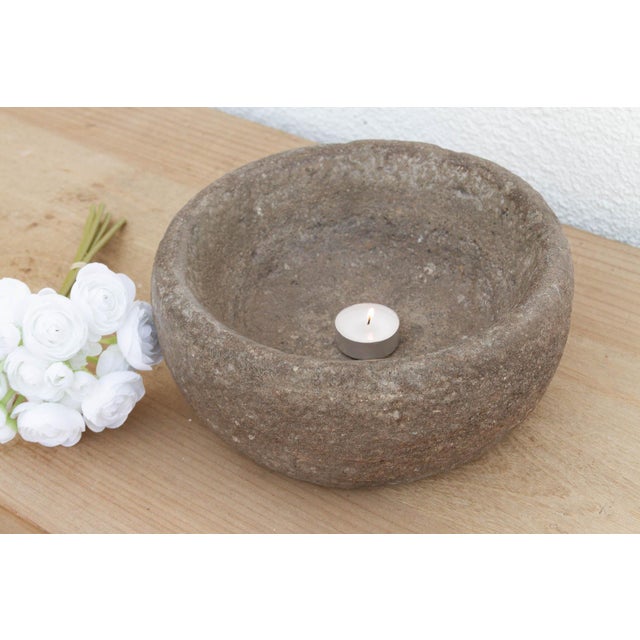 This heavy stone mortar is a relic of the "Old World" kitchen. Carved from a single block of solid granite, it was...