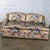 Marvelous vintage Traditional style small sofa or loveseat composed of front brass ball casters, round tapered wood back...