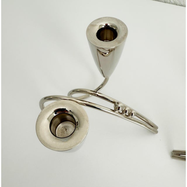 A pair of vintage 1940's Mexican Modernist-style, silver-toned metal candlesticks featuring an abstract curved shape....