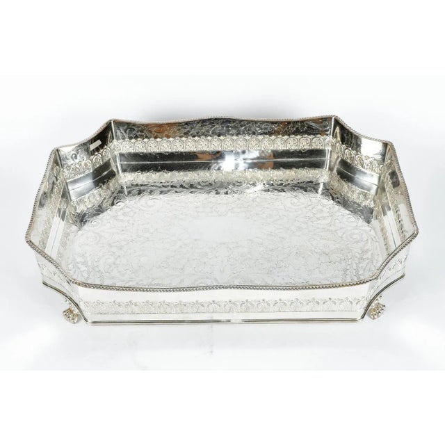 Large eight-sided English footed silver plate barware or serving tray with intricate interior design details work. In...