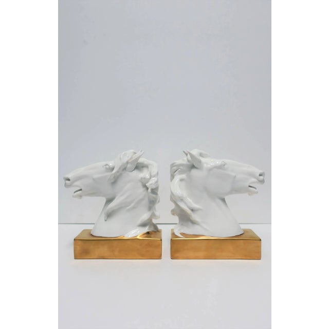 A beautiful and fine pair of white and gold porcelain horse or equine bookends or decorative objects/sculptures, circa...