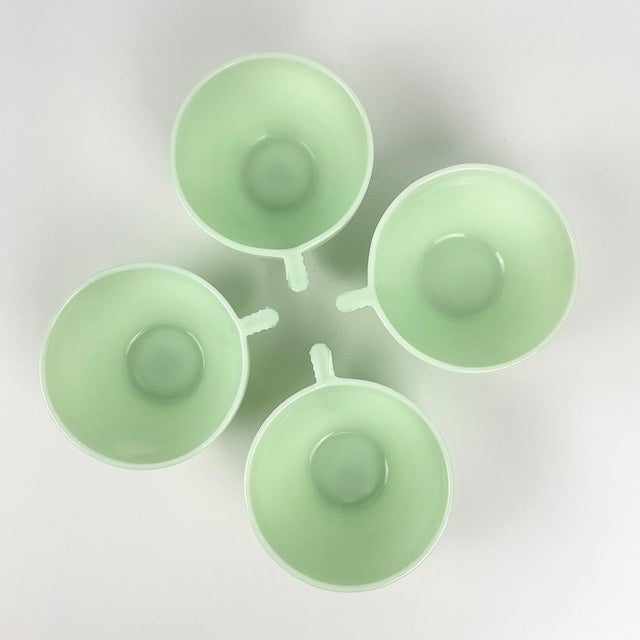 Mint green opaline glass coffee set comprising 4 cups and saucers Made in France Circa 50 Total weight: 1150 g Dimensions...