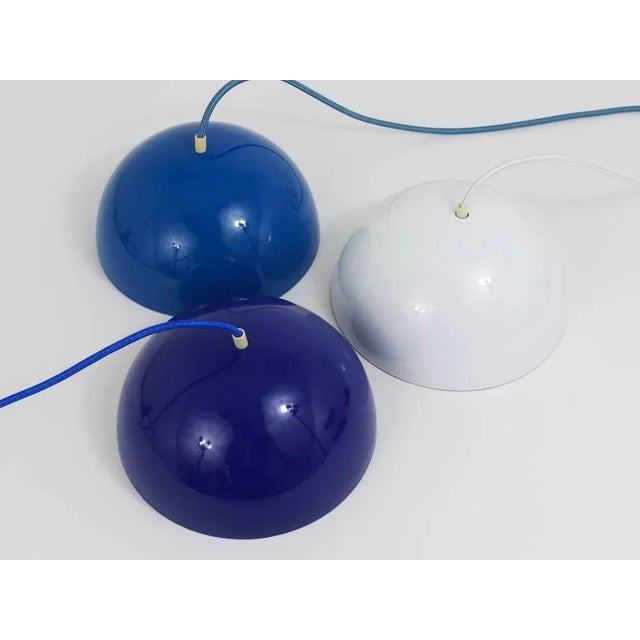 An iconic cobalt-blue flowerpot pendant light, designed in 1969 by Verner Panton for Louis Pulsen, Denmark. A simple but...