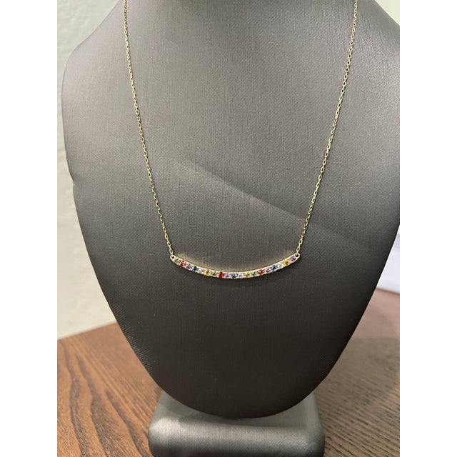 This necklace has Natural Multicolor Sapphires that weigh 1.29 carats. Made in 14 Karat Yellow Gold weighing approximately...