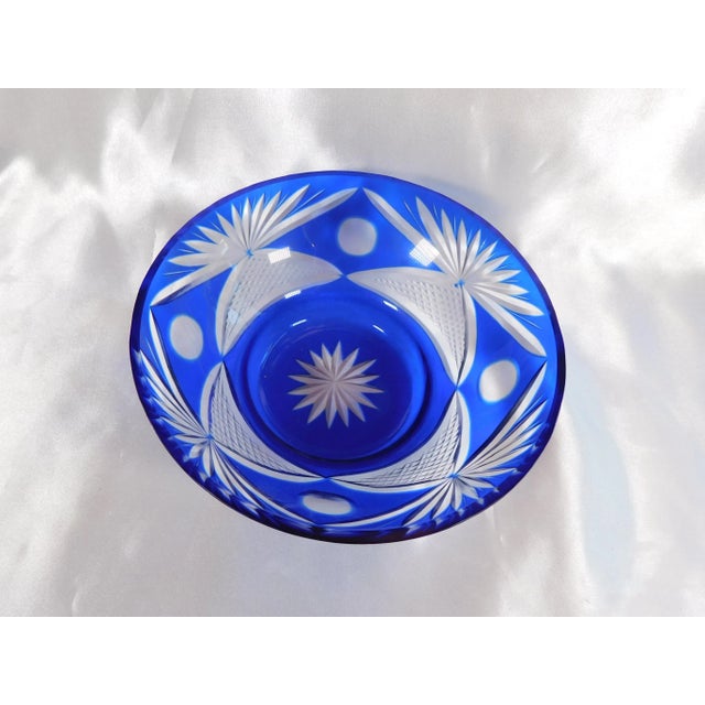 This is a blue cut to clear bowl. It can be used as small serving bowl, or as storage or a catchall. The blue glass is...