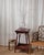 This charming antique side table has great character, with its original deep red paint, turned legs, and a sweet lower...