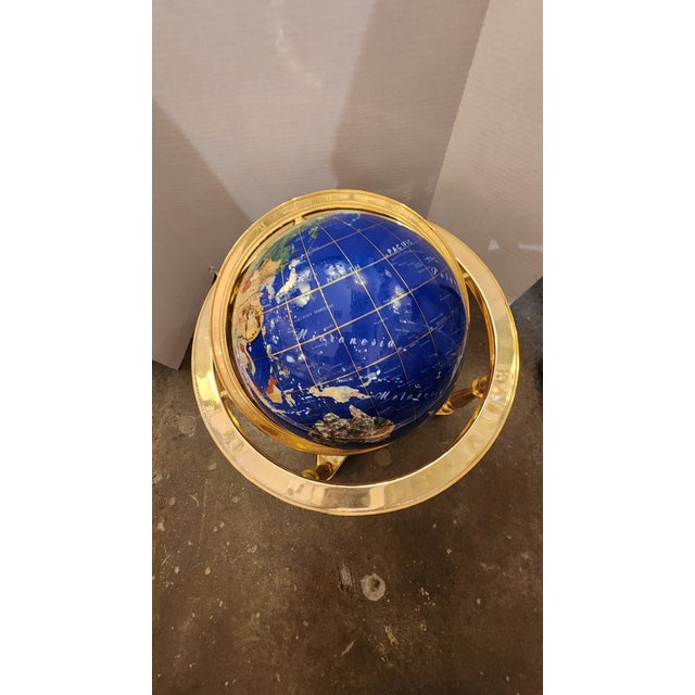 This listing features a faux hardstone rotating globe that has a brass frame, fully functional and moves seamlessly.