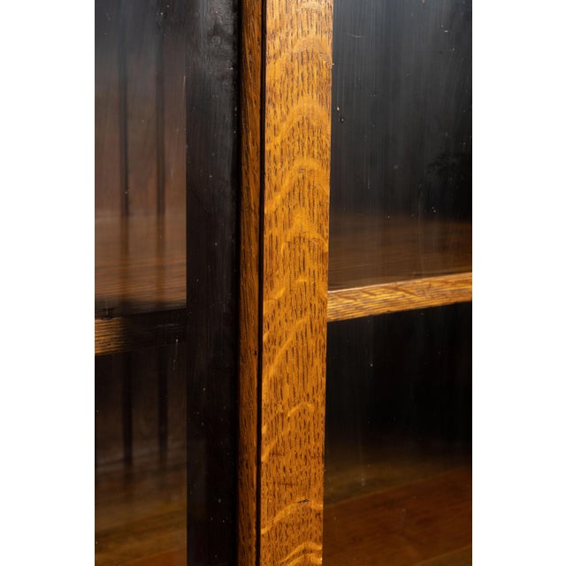 This Arts & Crafts-style cabinet was likely built sometime around 1920. This cabinet features sliding framed glass doors...