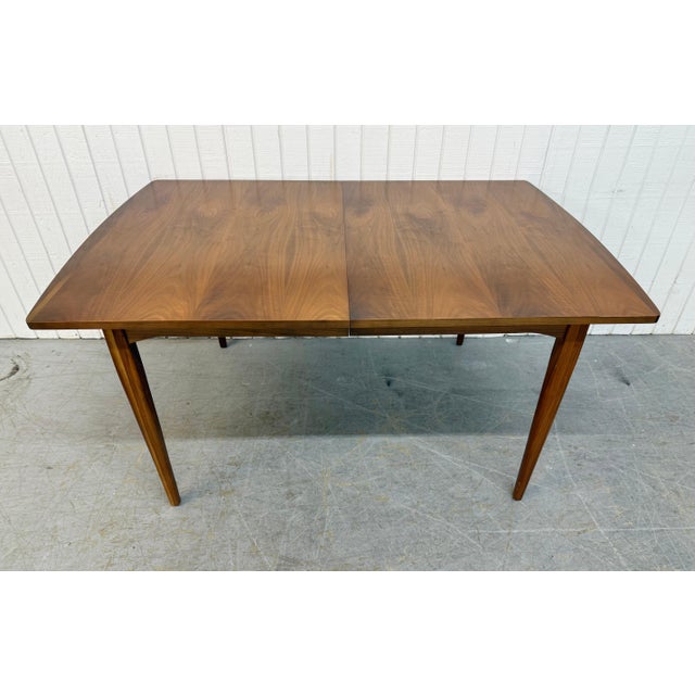 This listing is for a Mid-Century Modern Drexel Declaration Walnut Dining Table. Featuring a straight line design, two...