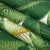 Custom-tailored pillow in an iconic tropical banana leaf print fabric. The pillow's back is made of complementary off-...
