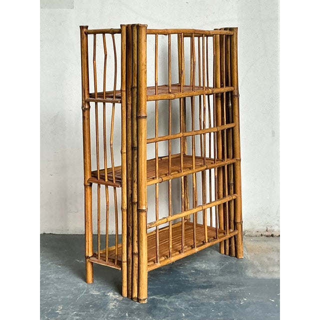 This charming vintage etagere is a quintessential example of tropical and Boho Chic design, crafted entirely from natural...