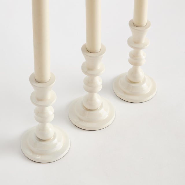 Traditional style in a contemporary fabrication, this set of taper holders is designerinspired. Made of enamel coated...