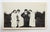 Early 20th century snapshot photograph of girls with guys in a headlock. Unframed, small corner crease.