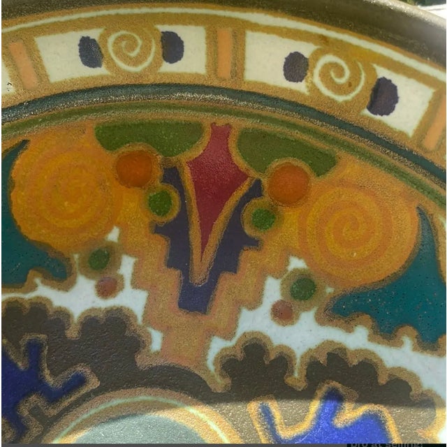 A hand-painted plateel bowl in the "isolde" decor by the arnhemsche fayencefabriek, the short-lived arnhem workshop whose...