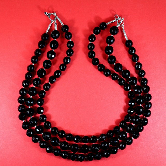 **Elegant Three-Strand Faceted Black Onyx Necklace** Add a touch of timeless sophistication to your jewelry collection...