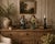 A charming pair of vintage Chinese ceramic figurines depicting rural farmers carrying traditional shoulder yokes with...