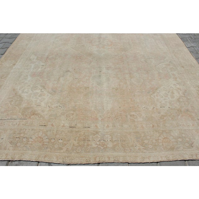 This beautiful, traditional vintage, hand knotted Turkish area rug is approximately 60 years old. It is handmade of very...