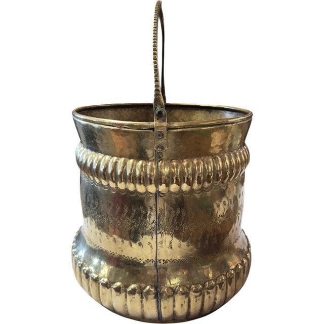 The vessel features traditional French repoussé and hand-chased metallic work, creating a deeply textured, decorative...