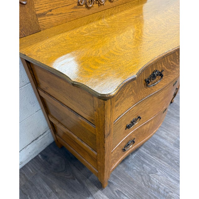 This is a beautiful antique Victorian tiger oak serpentine dresser with its original beveled mirror, dating to...