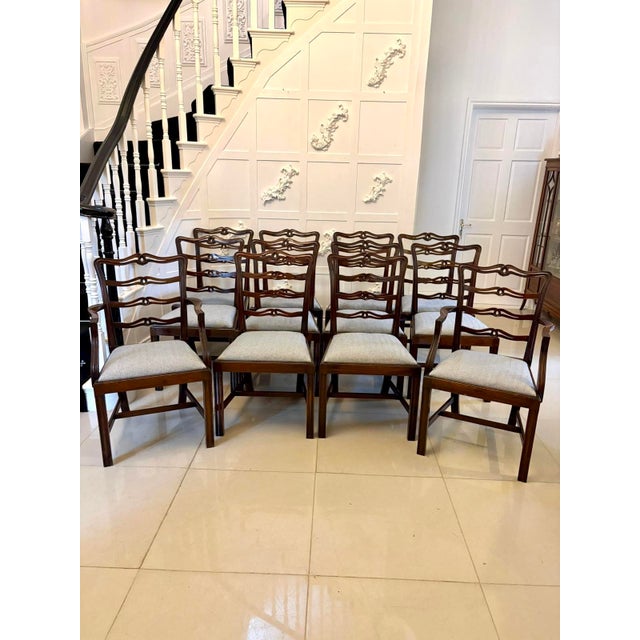 A superb set of twelve antique mahogany dining chairs comprising ten single chairs and two carvers, crafted in the classic...