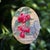 This mixed media piece features a vibrant arrangement of wax apples intertwined with lush greenery, set against a backdrop...