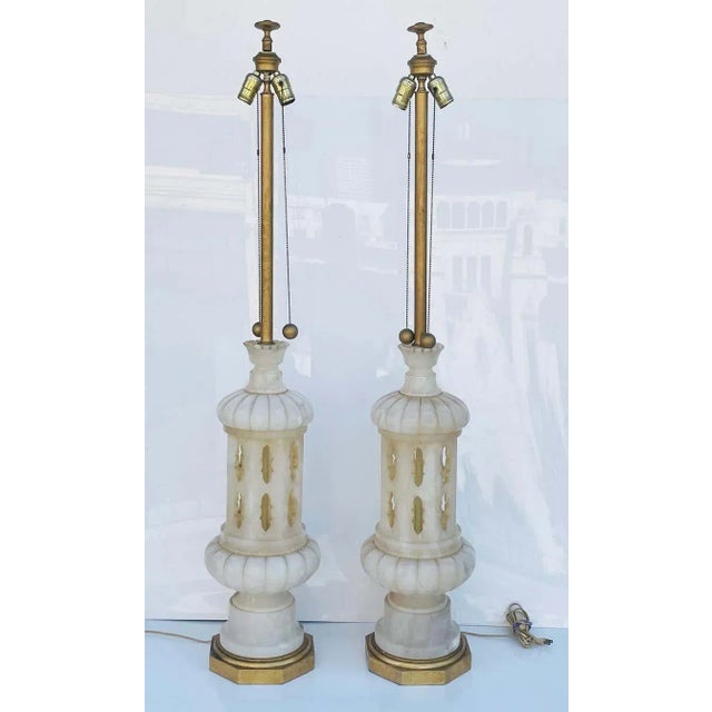 Monumental pair of Italian made marble lamps having gilded-octagonal wooden bases and long brass necks. The lamps have...
