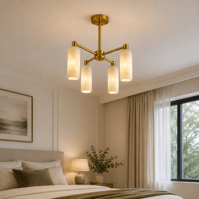Add a warm architectural presence to your interior with this handcrafted 4-light brass chandelier, designed with four...