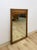 This vintage mid-century mirror features a rich walnut-toned wood frame with distinctive bowtie inlay detailing at the...