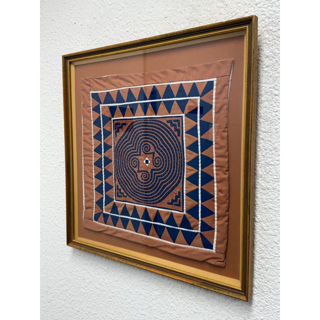 Design Plus Gallery presents a Framed Hmong Textile Folk Art Piece. This square textile work showcases blue and tan...