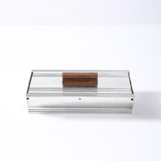 This elegant cigarette box by Kensington, crafted circa 1935, is a quintessential example of Art Deco Machine Age design,...
