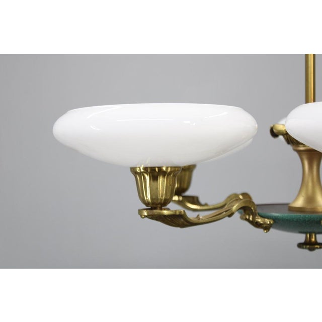 Original art deco chandelier produced by lyfa, denmark, circa 1940s. Executed in brass and metal with five white glass...