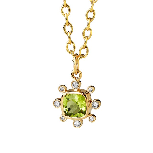 This pendant from our Cosmic collection has a vibrant, cushion-cut gemstone as its centerpiece. A unique halo of diamond...