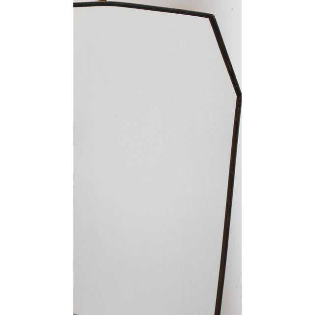 Mid-century italian wall mirror with brass frame (circa 1960s). The mirror is classically-shaped and distinctive in a...