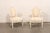 A French pair of Louis XVI style, carved-wood and upholstered armchairs from the 19th century. This antique pair of...
