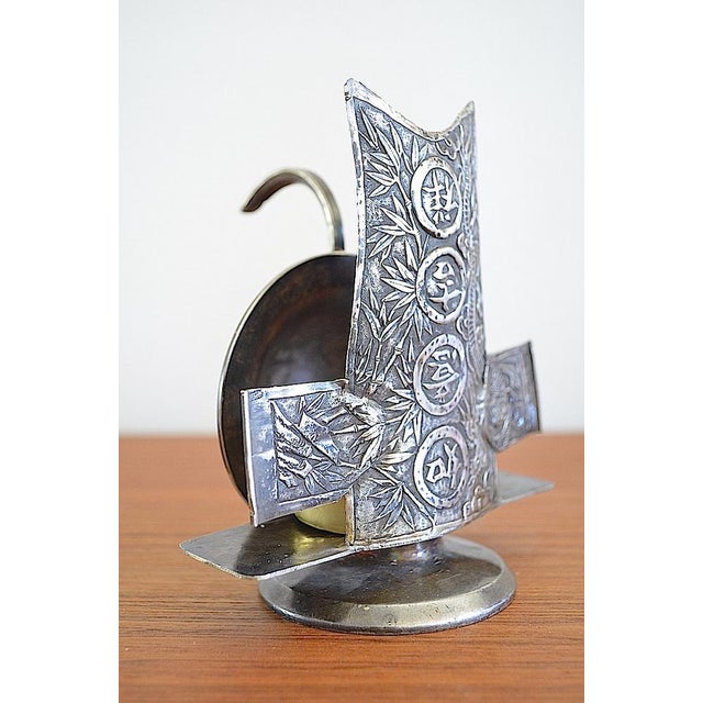 Antique candlestick from around 1890. The candlestick is made of metal, probably silver-plated, and appears to be a...