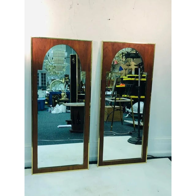 Pair of modern mirrors with brass interior design, 1970’s. Each measure 21 1/2” wide by 49 1/2” high, 1” deep. In good...
